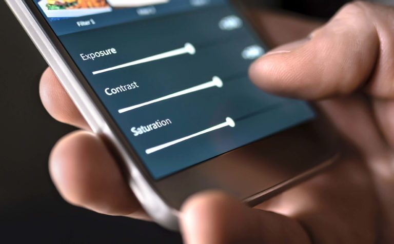 person using photo editing controls on mobile phone